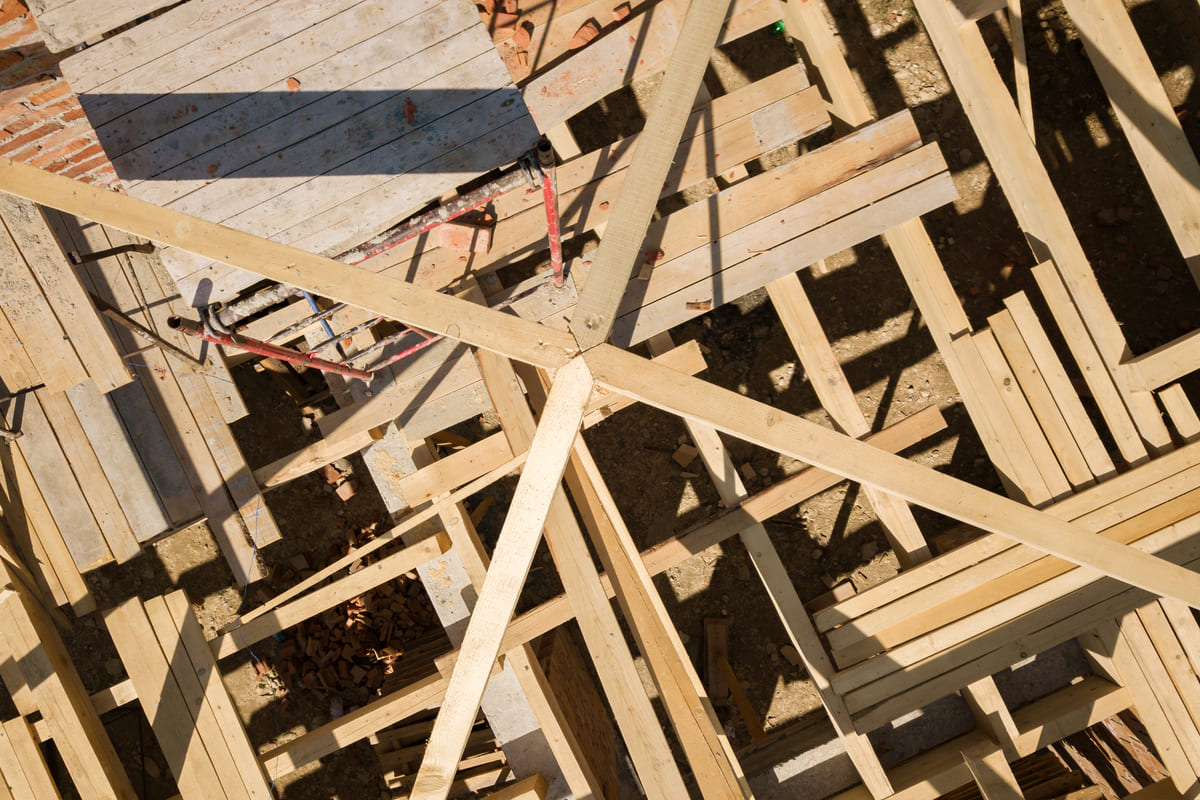 aerial-view-of-unfinished-brick-house-with-wooden-2022-01-12-06-33-25-utc