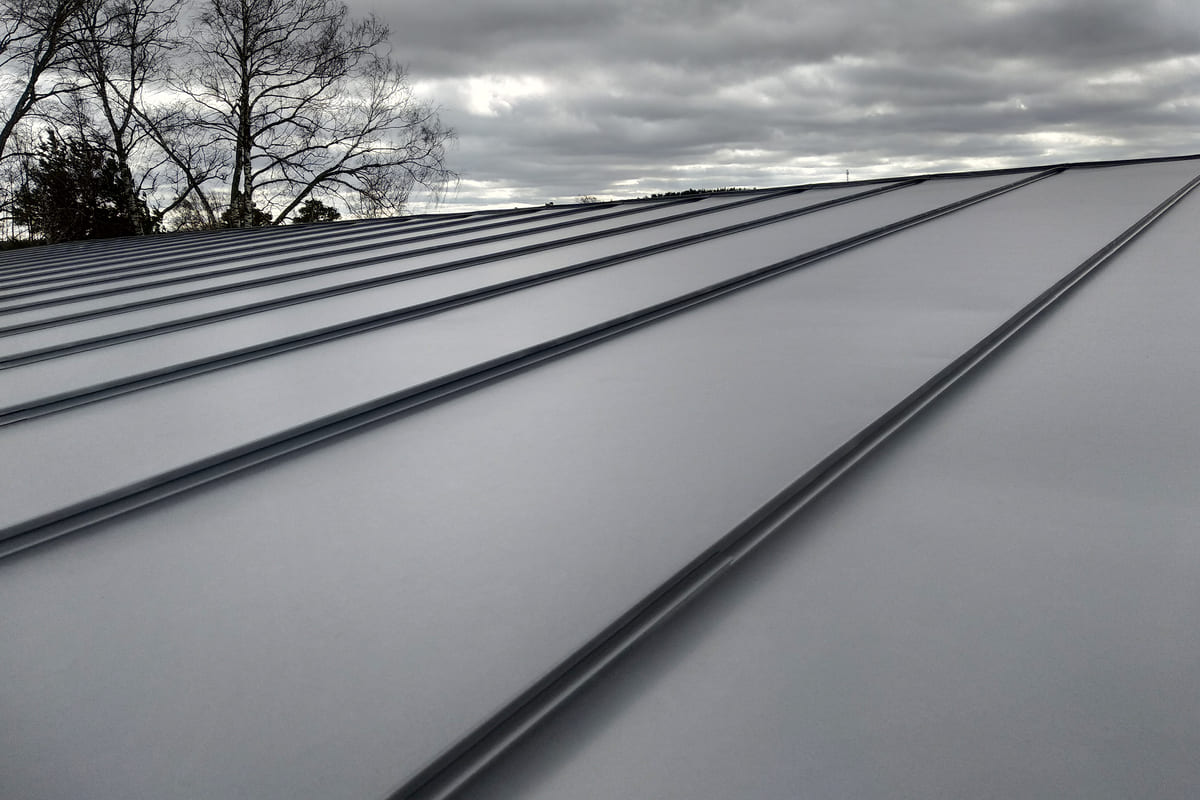 close-up-detail-of-house-roof-made-from-gray-metal-2022-12-01-05-06-05-utc-1